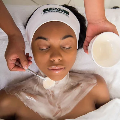 Women getting a protein amino acid facial anti aging with DMK Products