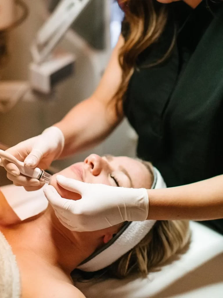 Woman receiving a DiamondGlow Facial treatment from a licensed esthetician at Skin by Carla Spa in Los Angeles